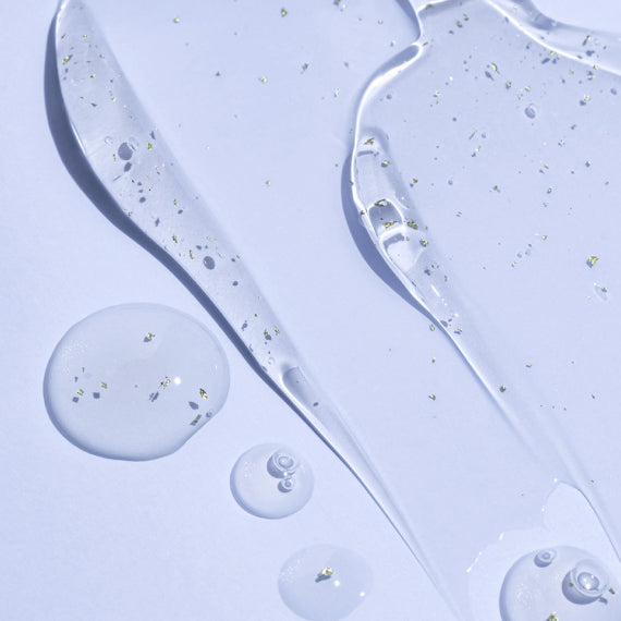 Close-up of clear drops of hyaluronan on a surface. The drops are small, translucent, and have a smooth, liquid texture. Hyaluronan is a popular PCOS supplement that may help manage PCOS symptoms by supporting skin hydration, reducing inflammation, and improving joint health.