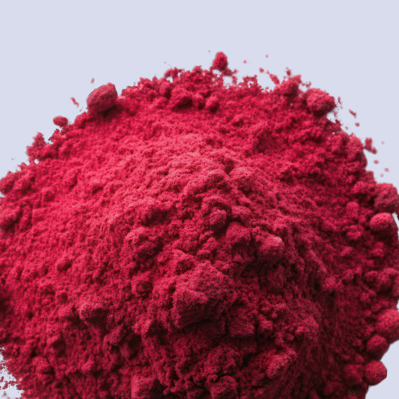 Close-up of bright red chromium powder scattered on a table. The powder has a fine texture and vibrant red color. Chromium is a PCOS supplement that may help manage PCOS symptoms by supporting healthy blood sugar levels and improving insulin sensitivity.