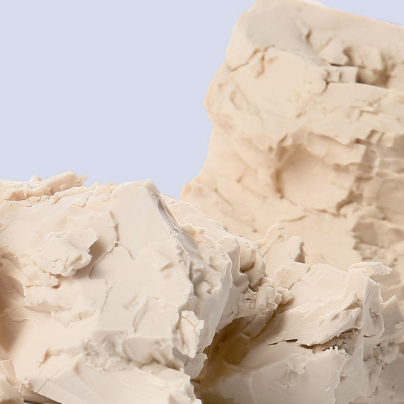 Close-up of a tan block of glutathione placed on a table. The block has a smooth, firm texture. Glutathione is a powerful antioxidant and a popular PCOS supplement that may help manage PCOS symptoms by supporting detoxification, reducing inflammation, and promoting hormonal balance