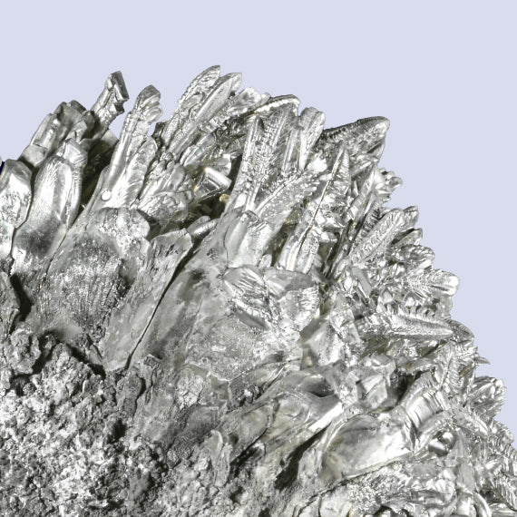 Close-up of a block of magnesium placed on a table. The block is solid, light gray in color, with a smooth, metallic surface. Magnesium is a popular PCOS supplement that may help manage PCOS symptoms by supporting muscle function, reducing stress, and improving insulin sensitivity