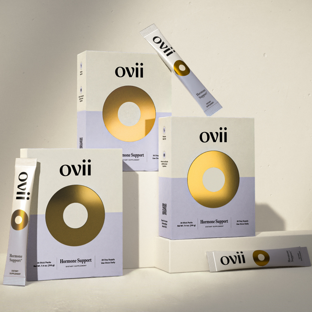Image of Ovii supplement packages arranged in a pyramid shape. The packages are stacked neatly, each displaying the product name and branding. Ovii supplements are formulated to help manage PCOS symptoms by promoting hormonal balance, regulating insulin levels, and supporting overall health for women with PCOS.